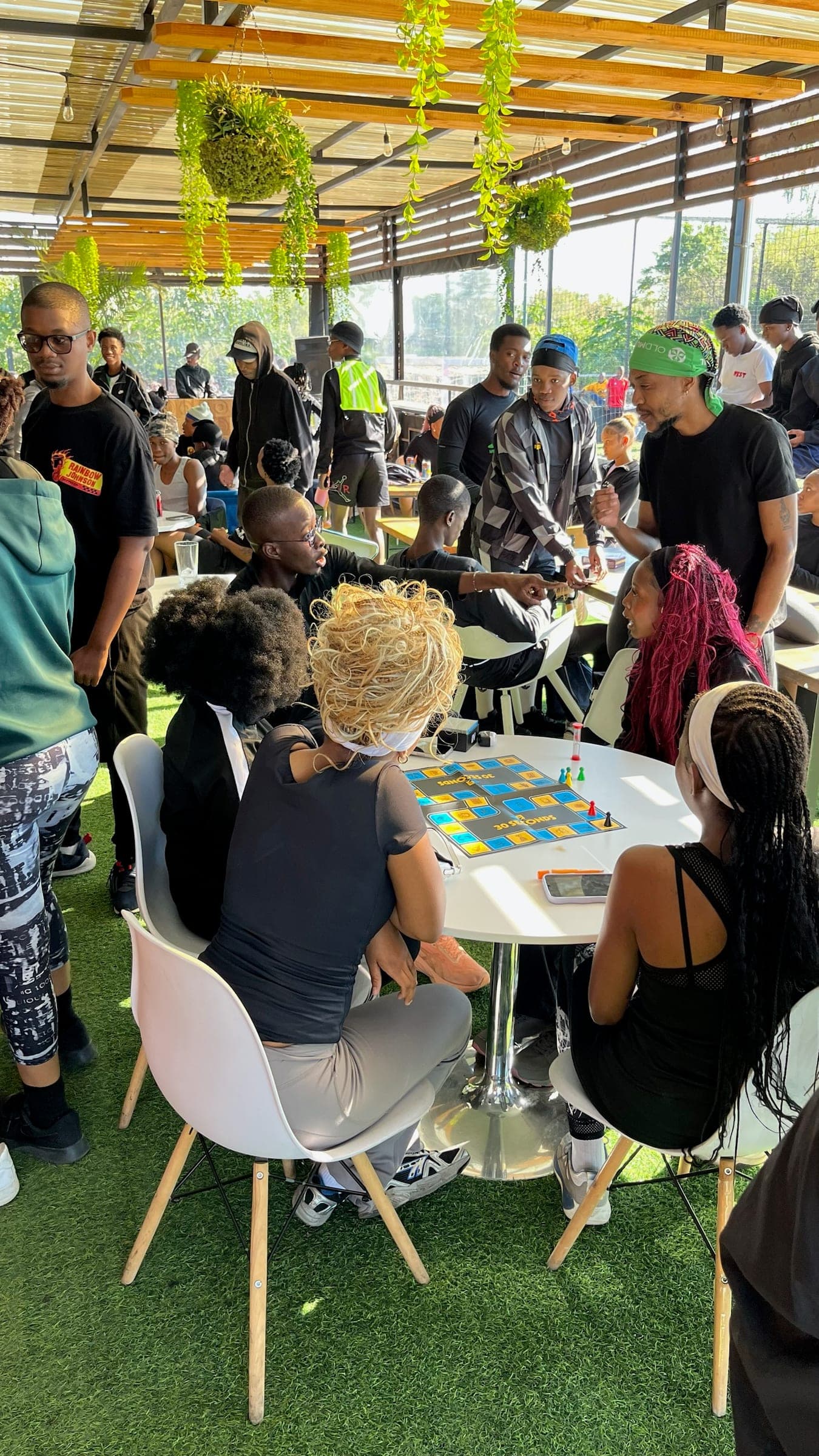 Members playing a board game around the clubhouse tables after a session