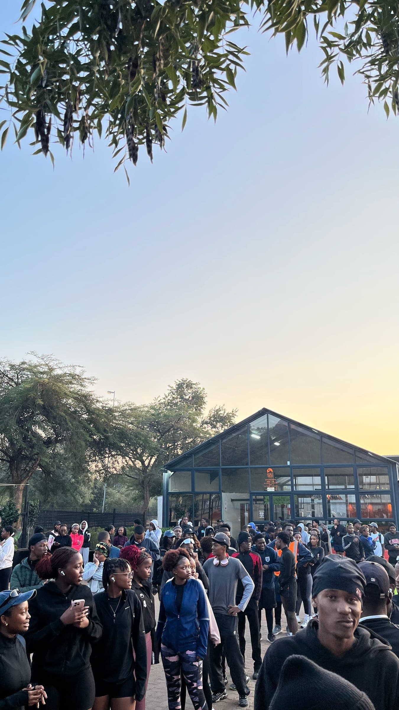 Runners gathering outside the clubhouse as the sun comes up