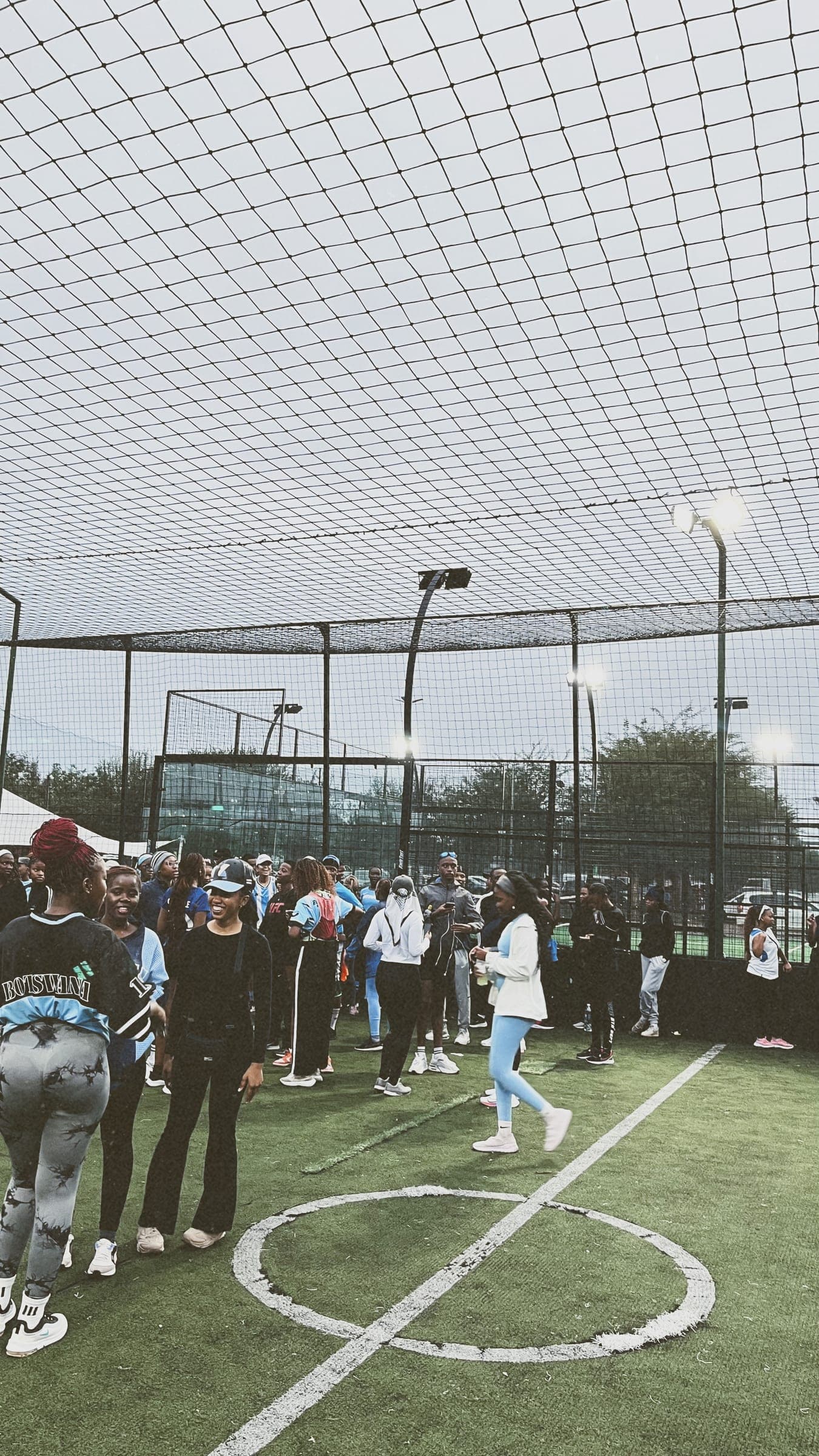 Members gathered around the centre circle of the turf pitch before a run