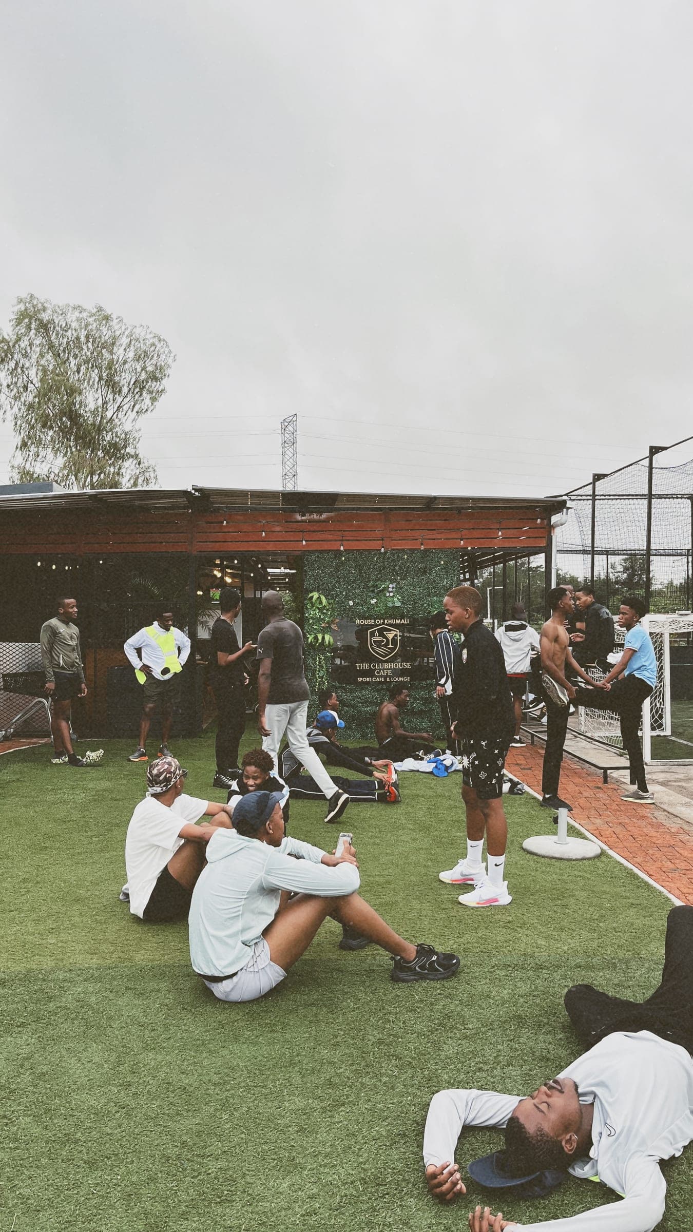 Members stretching and cooling down on the lawn outside the clubhouse
